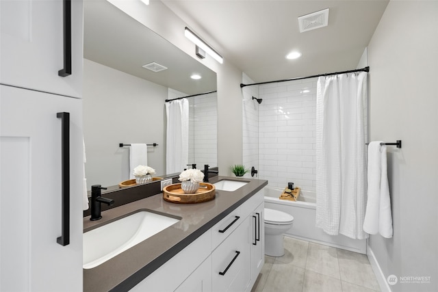 full bathroom with shower / bath combo, vanity, tile patterned floors, and toilet