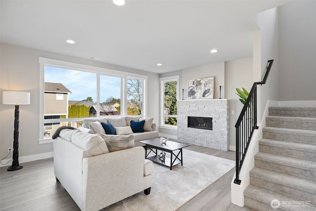 living room featuring a fireplace and light hardwood / wood-style flooring