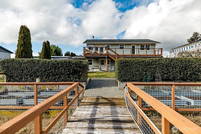 view of dock featuring a patio and a wooden deck