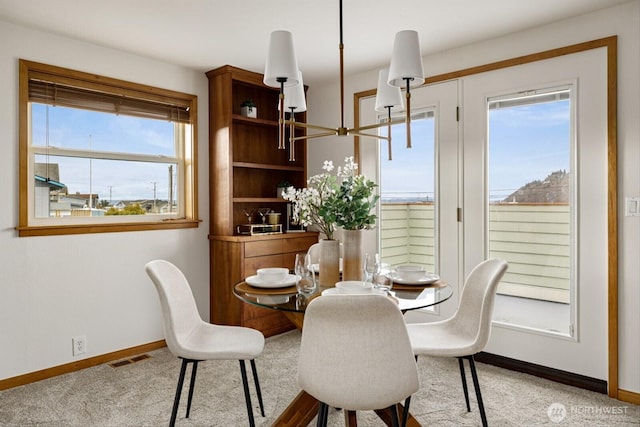 dining room featuring carpet flooring, visible vents, and baseboards