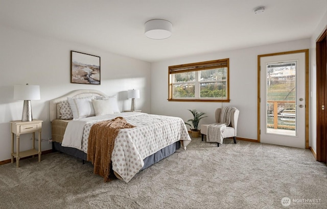 carpeted bedroom with access to outside and baseboards