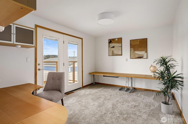 home office featuring carpet floors, visible vents, and baseboards