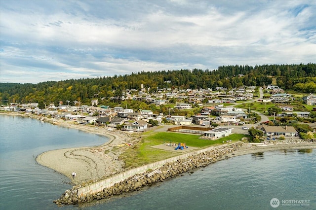 birds eye view of property with a water view, a residential view, and a view of trees