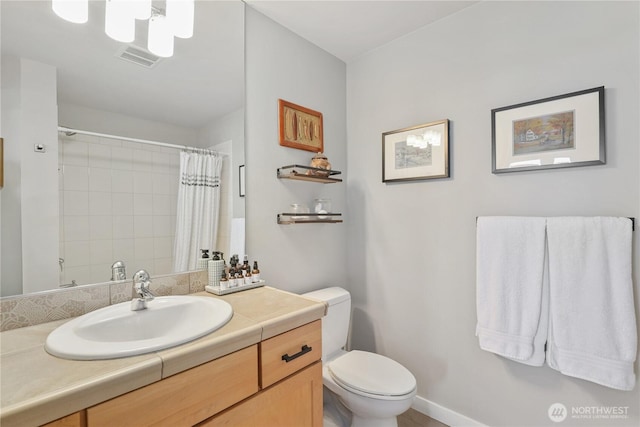 bathroom with vanity, a shower with shower curtain, and toilet