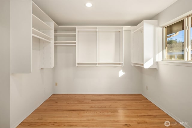 spacious closet featuring light hardwood / wood-style flooring