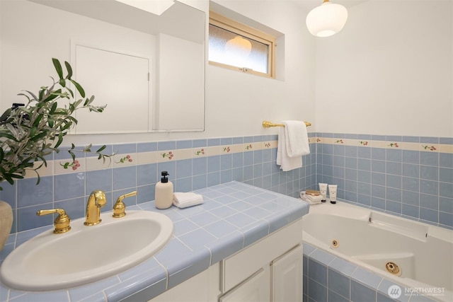 bathroom with vanity and tiled bath