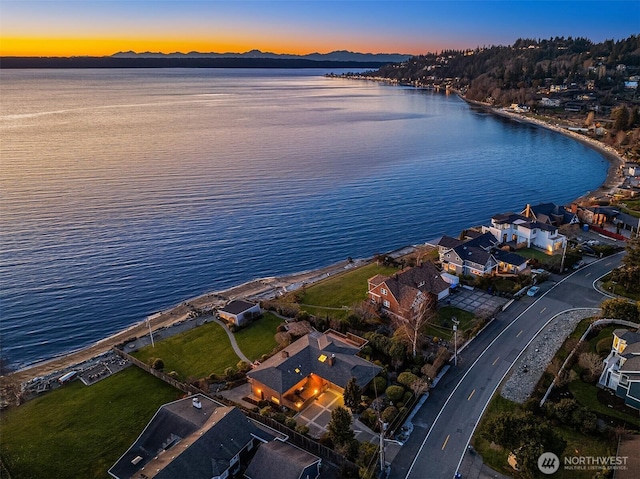 aerial view at dusk with a water view