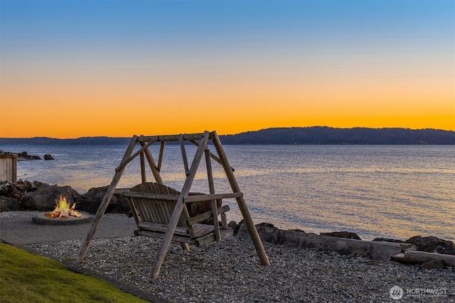 property view of water with a fire pit