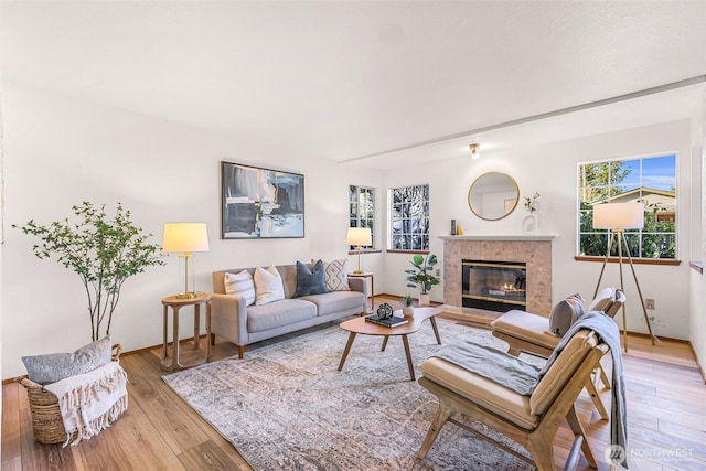 living room featuring a high end fireplace and hardwood / wood-style floors