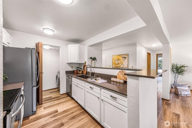 kitchen featuring white cabinetry, sink, light hardwood / wood-style floors, kitchen peninsula, and stainless steel appliances