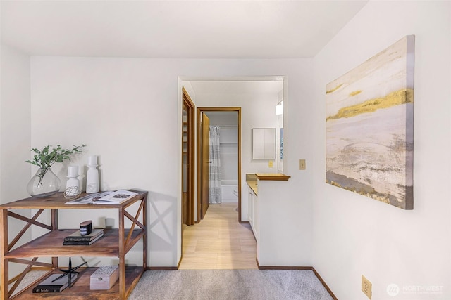 hallway with light hardwood / wood-style floors