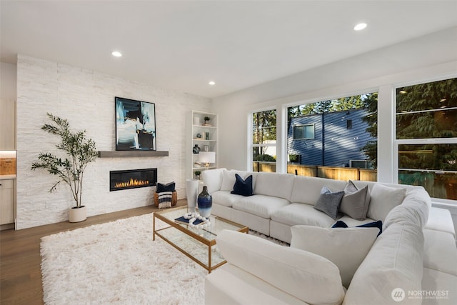 living area featuring a fireplace, wood finished floors, and recessed lighting