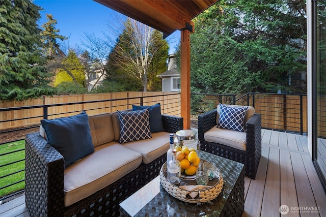 wooden deck with an outdoor hangout area and fence