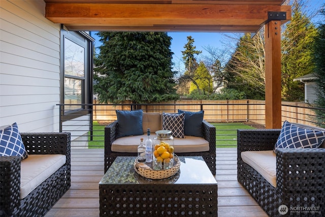 wooden terrace with fence and an outdoor living space