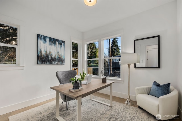 home office with wood finished floors and baseboards