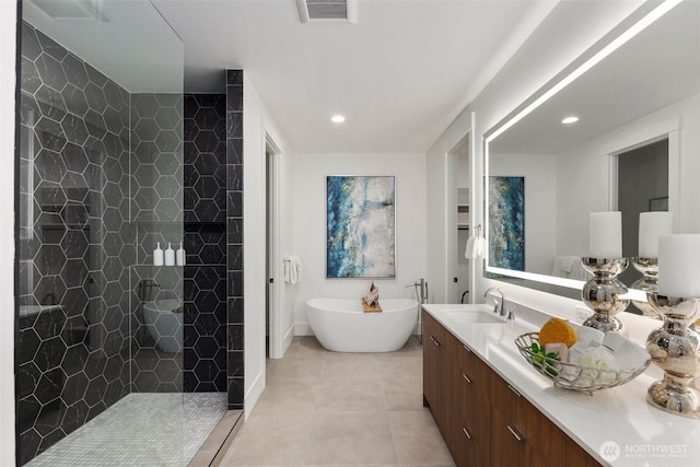 full bathroom with visible vents, tile patterned flooring, a freestanding bath, vanity, and a walk in shower