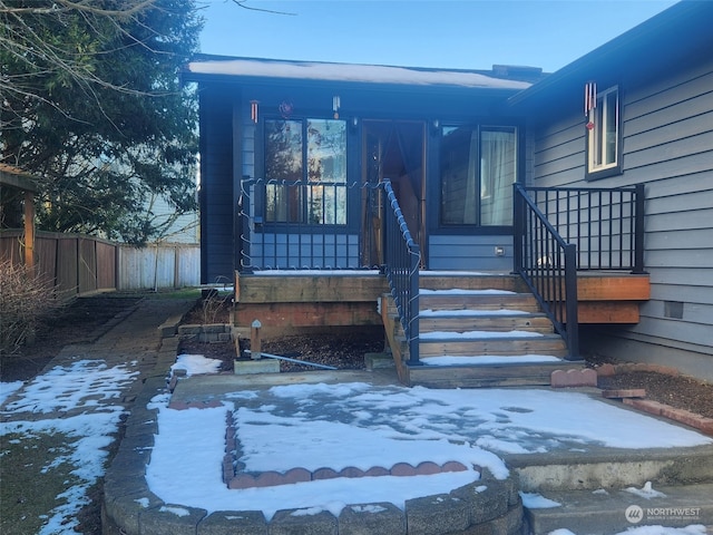 view of snow covered property entrance