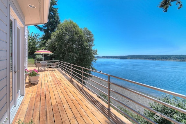 wooden terrace featuring a water view