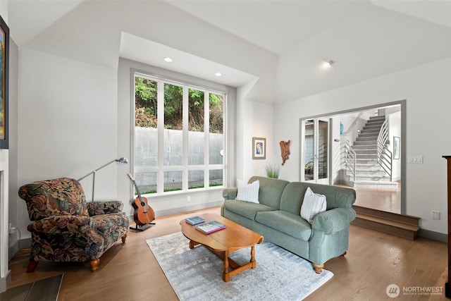 living room with stairs, recessed lighting, baseboards, and wood finished floors