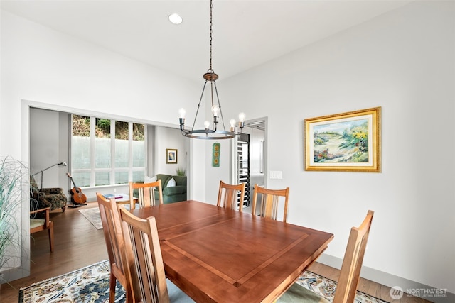 dining space with dark wood-style floors, baseboards, a notable chandelier, and recessed lighting