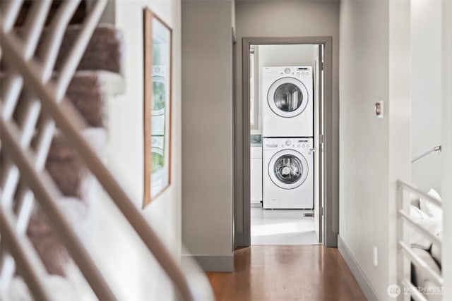 laundry area featuring stacked washing maching and dryer