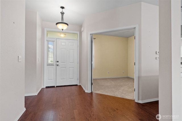 entrance foyer featuring baseboards and dark wood-style flooring