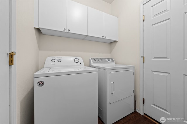 washroom with cabinet space, dark wood-style floors, and washing machine and clothes dryer