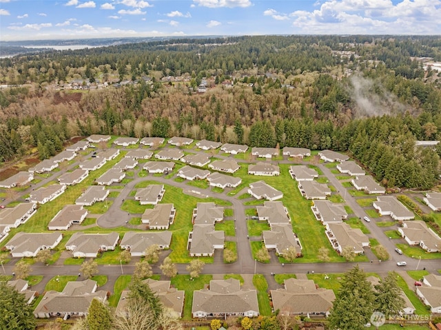 birds eye view of property with a forest view and a residential view