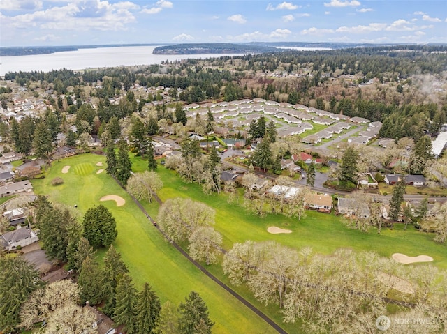 drone / aerial view with view of golf course and a water view