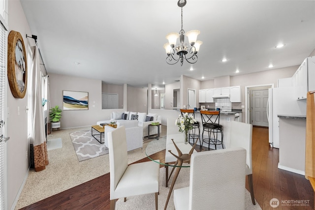 dining space featuring recessed lighting, baseboards, a chandelier, and dark wood finished floors