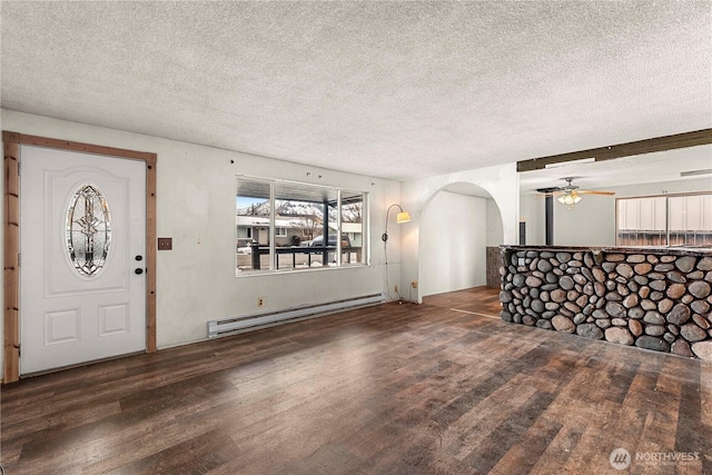 foyer featuring arched walkways, ceiling fan, baseboard heating, and wood finished floors