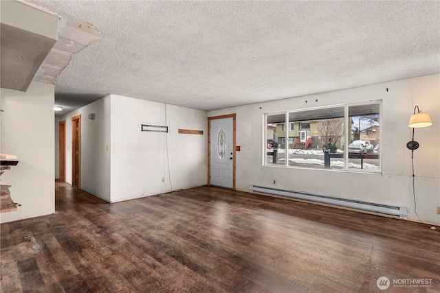 unfurnished living room featuring a baseboard heating unit, a textured ceiling, and wood finished floors