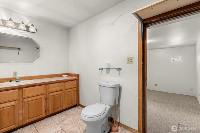 bathroom with tile patterned flooring, vanity, and toilet