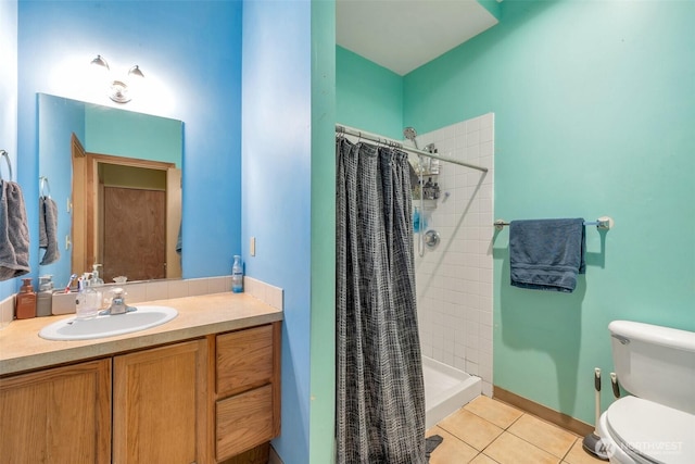 bathroom featuring toilet, a shower stall, vanity, and tile patterned floors