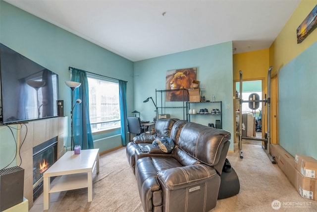 living room with a glass covered fireplace and light colored carpet