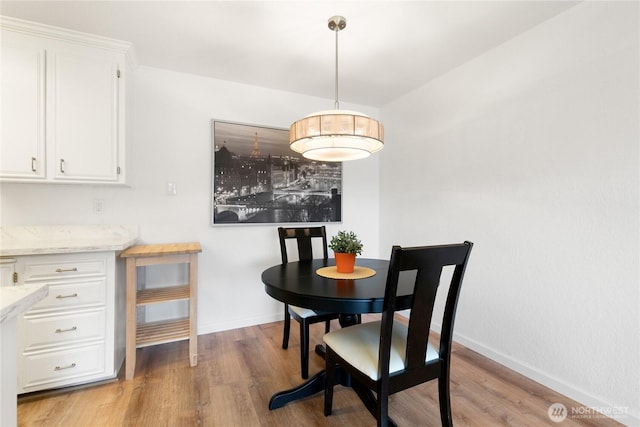 dining space with light wood-type flooring