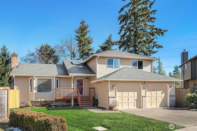 split level home with a garage and a front lawn