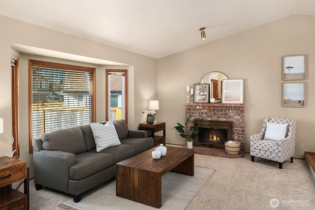 living room featuring lofted ceiling, light colored carpet, and a fireplace