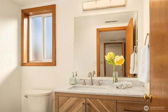 bathroom with vanity and toilet