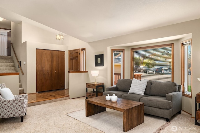 living room featuring lofted ceiling and light colored carpet