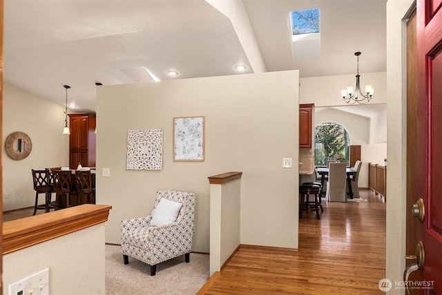 hall featuring hardwood / wood-style floors and a notable chandelier