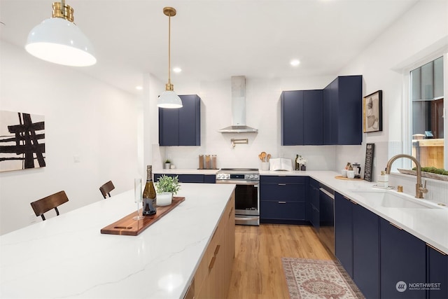 kitchen with sink, electric range, a kitchen breakfast bar, blue cabinets, and wall chimney exhaust hood