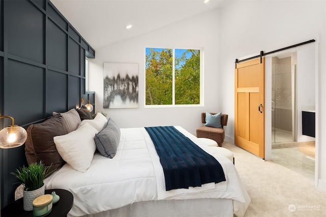 bedroom featuring a barn door, vaulted ceiling, and light carpet