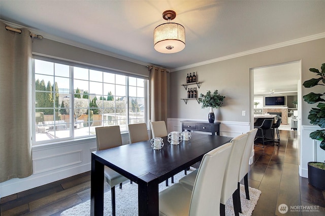 dining room with crown molding and dark hardwood / wood-style floors