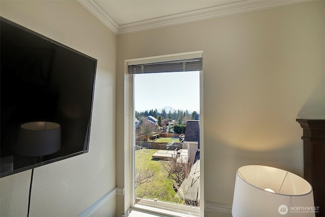 doorway to outside featuring crown molding and a healthy amount of sunlight