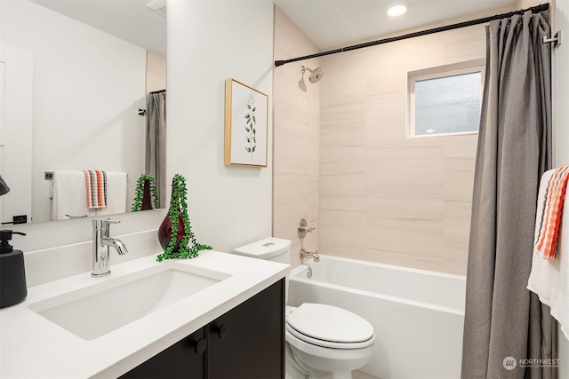 full bathroom with shower / bathtub combination with curtain, vanity, and toilet