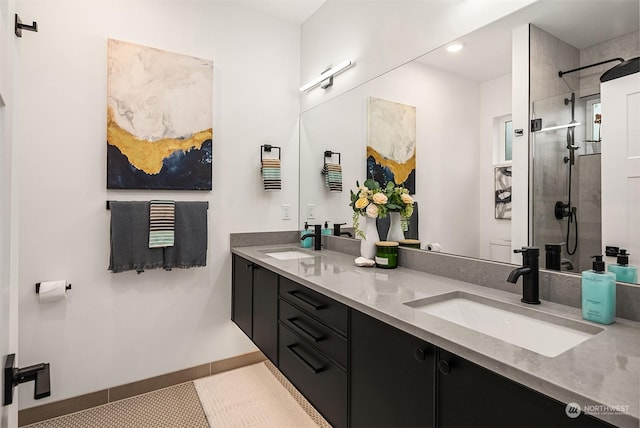 bathroom with vanity, tile patterned flooring, and a tile shower