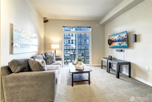 living area featuring baseboards and carpet floors