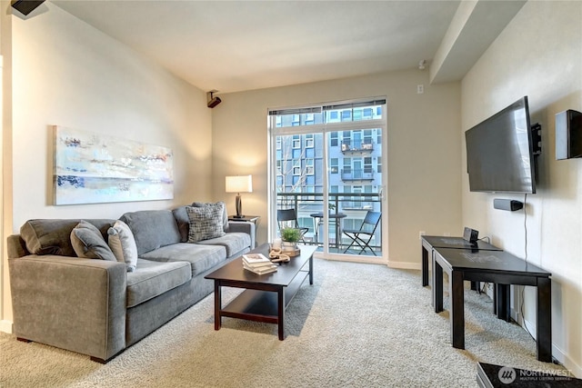 carpeted living room with baseboards