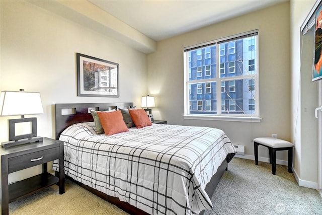 bedroom featuring baseboards and carpet